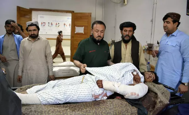 An injured man receives treatment at a hospital in Quetta, Pakistan, Friday, Oct. 11, 2024, following Thursday attack by gunmen in Balochistan province. (AP Photo/Arshad Butt)