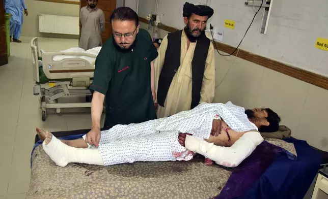 An injured man receives treatment at a hospital in Quetta, Pakistan, Friday, Oct. 11, 2024, following Thursday night's attack by gunmen in Balochistan province. (AP Photo/Arshad Butt)