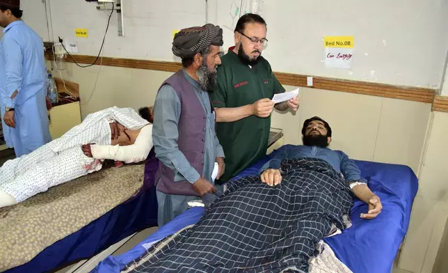 Injured men receive treatment at a hospital in Quetta, Pakistan, Friday, Oct. 11, 2024, following Thursday attack by gunmen in Balochistan province. (AP Photo/Arshad Butt)