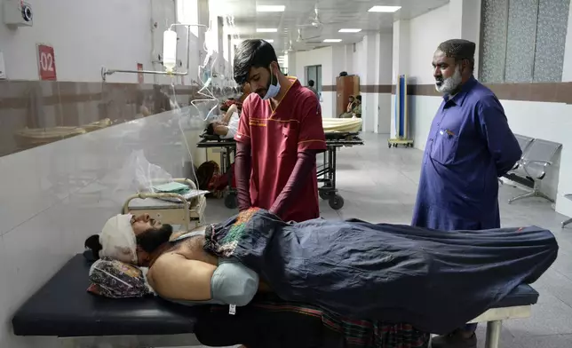 Injured men receive treatment at a hospital in Quetta, Pakistan, Friday, Oct. 11, 2024, following Thursday attack by gunmen in Balochistan province. (AP Photo/Arshad Butt)