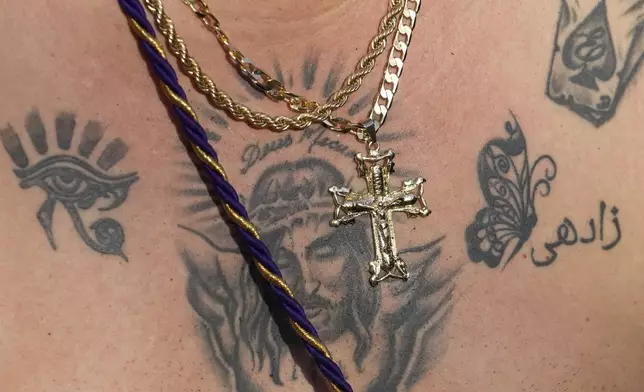 A tattoo of Christ covers the chest of pilgrim Ernesto Troya who crawls to San Felipe Church to honor the Black Christ in Portobelo, Panama, Monday, Oct. 21, 2024, during a festival celebrating the statue that was found on the shore in 1658. (AP Photo/Matias Delacroix)