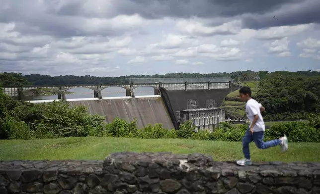 A youth runs near the Panama Canal's Madden Dam at Alajuela Lake in Colon, Panama, Monday, Sept. 2, 2024. (AP Photo/Matias Delacroix)