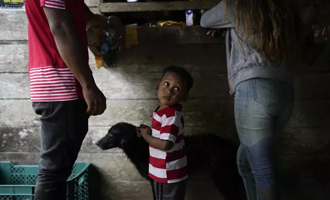 Jadiel Magallon waits as his parents grocery shop in the community of Limon, which could be submerged in a proposed plan to dam the nearby Indio River to secure the Panama Canal’s uninterrupted operation, in Panama, Saturday, Aug. 31, 2024. (AP Photo/Matias Delacroix)