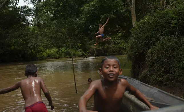 Children in El Jobo village play in the Indio River, which could have its flow reduced under a proposed plan to secure the Panama Canal’s uninterrupted operation in Panama, Saturday, Aug. 31, 2024. (AP Photo/Matias Delacroix)