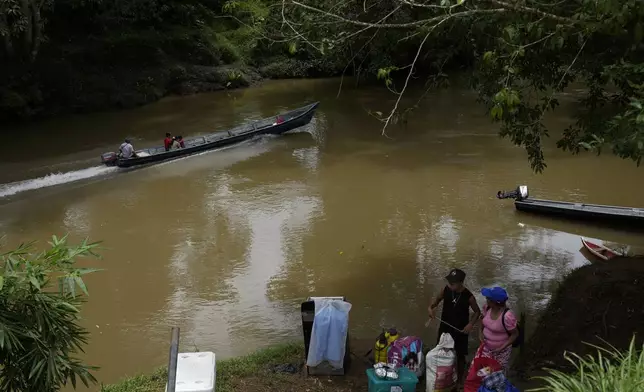 Locals commute along the Indio River near El Jobo village, Panama, Saturday, Aug. 31, 2024. El Jobo could lose reliable access to water under a proposed plan to dam the river to secure the Panama Canal’s uninterrupted operation. (AP Photo/Matias Delacroix)