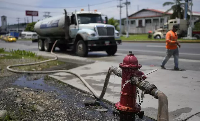 A water truck fills up at a fire hydrant to distribute to buildings in Colon, Panama, Monday, Sept. 2, 2024. In a proposed plan to dam the nearby Indio River and secure the Panama Canal's uninterrupted operation, the community would gain more reliable access to water. (AP Photo/Matias Delacroix)