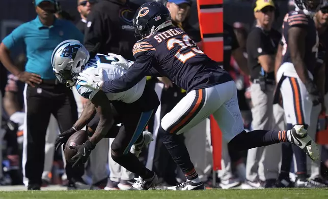 Carolina Panthers wide receiver Diontae Johnson (5) pulls in a reception as Chicago Bears cornerback Tyrique Stevenson (29) defends during the second half of an NFL football game Sunday, Oct. 6, 2024, in Chicago. (AP Photo/Charles Rex Arbogast)