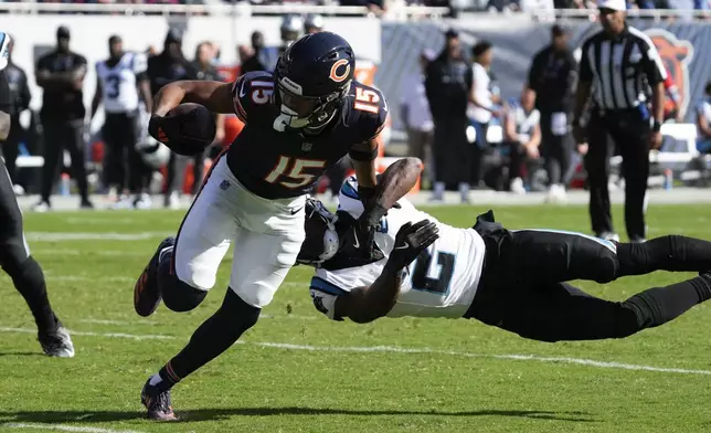 Chicago Bears wide receiver Rome Odunze (15) sheds the tackle of Carolina Panthers cornerback Michael Jackson (2) during the second half of an NFL football game Sunday, Oct. 6, 2024, in Chicago. (AP Photo/Nam Y. Huh)