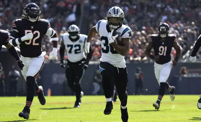 Carolina Panthers running back Chuba Hubbard (30) runs for a 38-yard touchdown against the Chicago Bears during the first half of an NFL football game Sunday, Oct. 6, 2024, in Chicago. (AP Photo/Nam Y. Huh)