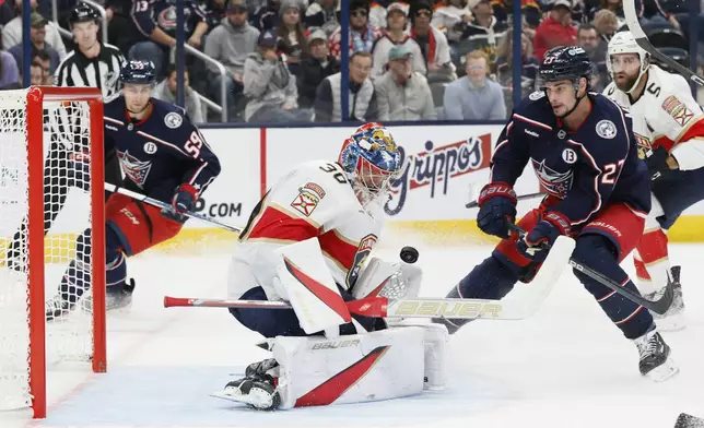 Columbus Blue Jackets' Sean Monahan, right, scores a goal against Florida Panthers' Spencer Knight during the second period of an NHL hockey game Tuesday, Oct. 15, 2024, in Columbus, Ohio. (AP Photo/Jay LaPrete)