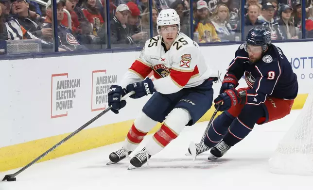 Florida Panthers' Mackie Samoskevich, left, skates past Columbus Blue Jackets' Ivan Provorov during the first period of an NHL hockey game, Tuesday, Oct. 15, 2024, in Columbus, Ohio. (AP Photo/Jay LaPrete)