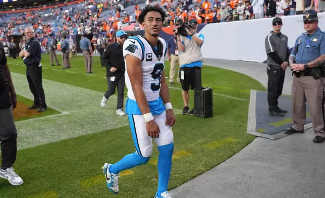 Carolina Panthers quarterback Bryce Young walks off the field after an NFL football game against the Denver Broncos, Sunday, Oct. 27, 2024, in Denver. (AP Photo/David Zalubowski)