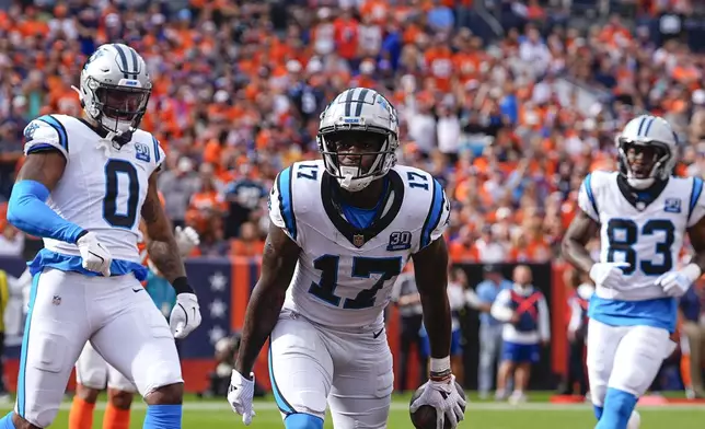 Carolina Panthers wide receiver Xavier Legette (17) celebrates catching a pass for a touchdown during the first half of an NFL football game against the Denver Broncos, Sunday, Oct. 27, 2024, in Denver. (AP Photo/David Zalubowski)