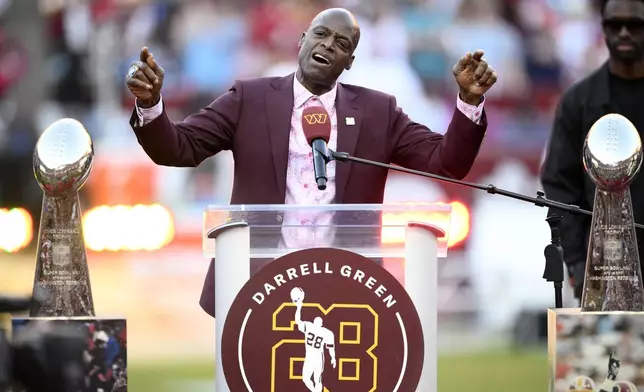 Former Washington defensive back Darrell Green speaks during a jersey retirement ceremony at halftime of an NFL football game between the Washington Commanders and the Carolina Panthers, Sunday, Oct. 20, 2024, in Landover, Md. (AP Photo/Nick Wass)
