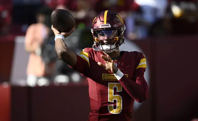 Washington Commanders quarterback Jayden Daniels warms up before an NFL football game against the Carolina Panthers, Sunday, Oct. 20, 2024, in Landover, Md. (AP Photo/Nick Wass)