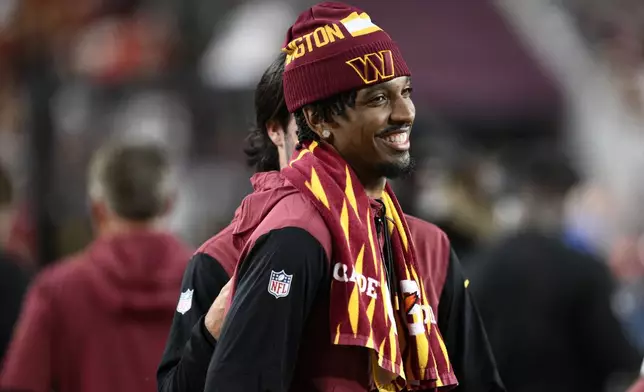 Washington Commanders quarterback Jayden Daniels stands on the sideline during the second half of an NFL football game against the Carolina Panthers, Sunday, Oct. 20, 2024, in Landover, Md. (AP Photo/Nick Wass)