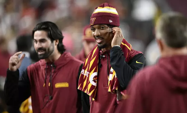 Washington Commanders quarterback Jayden Daniels stands on the sideline during the second half of an NFL football game against the Carolina Panthers, Sunday, Oct. 20, 2024, in Landover, Md. (AP Photo/Nick Wass)