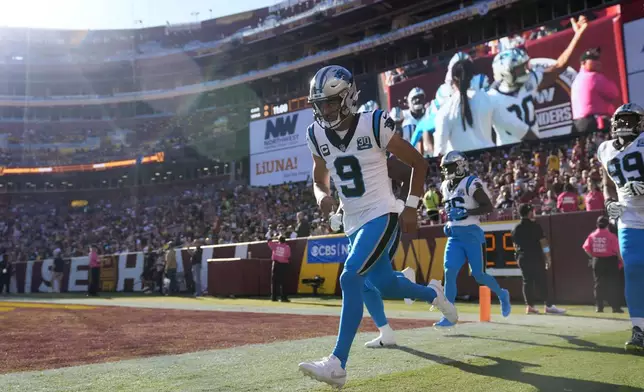 Carolina Panthers quarterback Bryce Young (9) runs onto the field before an NFL football game against the Washington Commanders, Sunday, Oct. 20, 2024, in Landover, Md. (AP Photo/Stephanie Scarbrough)