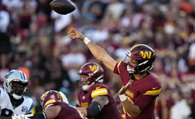 Washington Commanders quarterback Marcus Mariota throws a pass during the first half of an NFL football game against the Carolina Panthers, Sunday, Oct. 20, 2024, in Landover, Md. (AP Photo/Stephanie Scarbrough)