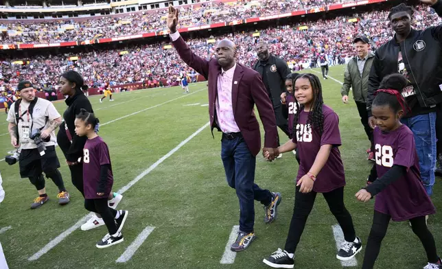Former Washington defensive back Darrell Green reacts to fans after a jersey retirement ceremony at halftime of an NFL football game between the Washington Commanders and the Carolina Panthers, Sunday, Oct. 20, 2024, in Landover, Md. (AP Photo/Nick Wass)