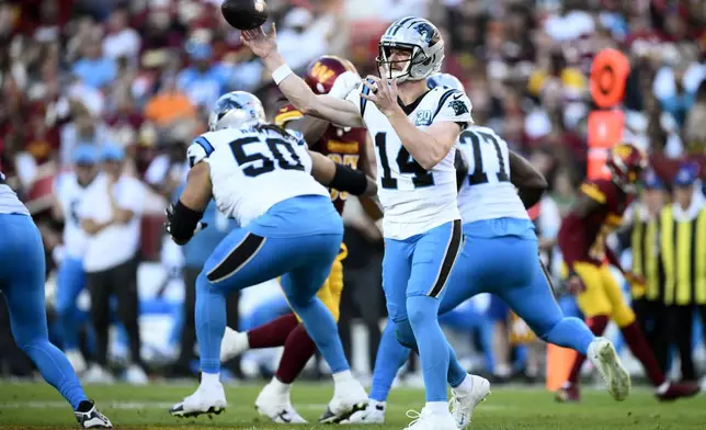 Carolina Panthers quarterback Andy Dalton (14) throws a pass during the first half of an NFL football game against the Washington Commanders, Sunday, Oct. 20, 2024, in Landover, Md. (AP Photo/Nick Wass)