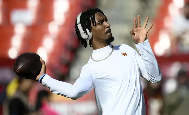 Washington Commanders quarterback Jayden Daniels warms up before an NFL football game against the Carolina Panthers, Sunday, Oct. 20, 2024, in Landover, Md. (AP Photo/Nick Wass)