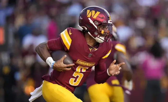 Washington Commanders quarterback Jayden Daniels runs up field during the first half of an NFL football game against the Carolina Panthers, Sunday, Oct. 20, 2024, in Landover, Md. (AP Photo/Stephanie Scarbrough)