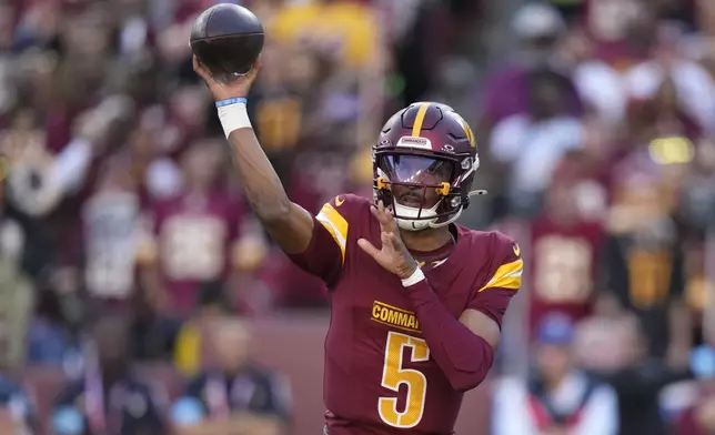 Washington Commanders quarterback Jayden Daniels throws a pass during the first half of an NFL football game against the Carolina Panthers, Sunday, Oct. 20, 2024, in Landover, Md. (AP Photo/Stephanie Scarbrough)