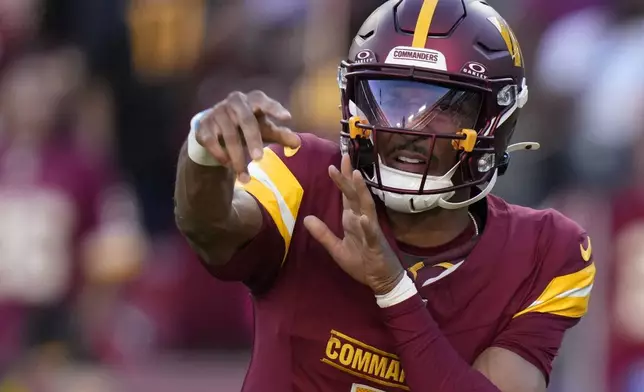 Washington Commanders quarterback Jayden Daniels throws a pass during the first half of an NFL football game against the Carolina Panthers, Sunday, Oct. 20, 2024, in Landover, Md. (AP Photo/Stephanie Scarbrough)