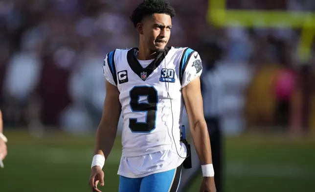 Carolina Panthers quarterback Bryce Young watches from the sideline during the first half of an NFL football game against the Washington Commanders, Sunday, Oct. 20, 2024, in Landover, Md. (AP Photo/Stephanie Scarbrough)
