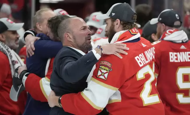 FILE - Florida Panthers general manager Bill Zito talks to defenseman Uvis Balinskis (26) after Game 7 of the NHL hockey Stanley Cup Final against the Edmonton Oilers, on June 24, 2024, in Sunrise, Fla. (AP Photo/Wilfredo Lee, File)