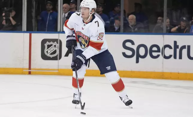 Florida Panthers' Dmitry Kulikov (7) looks to pass the puck during the first period of an NHL hockey game against the New York Rangers, Thursday, Oct. 24, 2024, in New York. (AP Photo/Frank Franklin II)