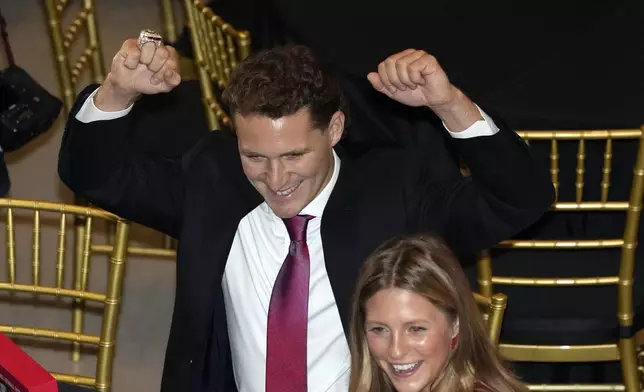 Florida Panthers left wing Matthew Tkachuk celebrates after opening the box containing his Stanley Cup championship ring, during a private ceremony commemorating the NHL team's last season's Stanley Cup title, Monday, Oct. 7, 2024, in Fort Lauderdale, Fla. (AP Photo/Wilfredo Lee)