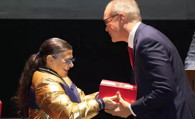 Florida Panthers head coach coach Paul Maurice, right, receives his Stanley Cup championship ring from Teresa Viola, wife of owner Vincent Viola, during a private ceremony commemorating the NHL team's Stanley Cup title last season, Monday, Oct. 7, 2024, in Fort Lauderdale, Fla. (AP Photo/Wilfredo Lee)