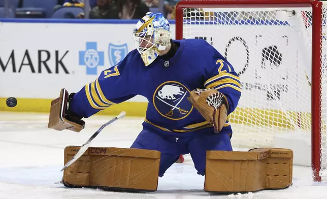 Buffalo Sabres goaltender Devon Levi (27) makes a blocker save during the second period of an NHL hockey game against the Florida Panthers, Saturday, Oct. 12, 2024, in Buffalo, N.Y. (AP Photo/Jeffrey T. Barnes)