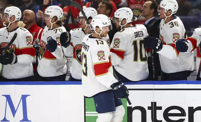 Florida Panthers center Sam Reinhart (13) celebrates his goal during the first period of an NHL hockey game against the Buffalo Sabres, Monday, Oct. 28, 2024, in Buffalo, N.Y. (AP Photo/Jeffrey T. Barnes)