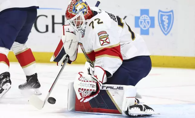 Florida Panthers goaltender Sergei Bobrovsky (72) looks to cover a loose puck during the first period of an NHL hockey game against the Buffalo Sabres, Monday, Oct. 28, 2024, in Buffalo, N.Y. (AP Photo/Jeffrey T. Barnes)