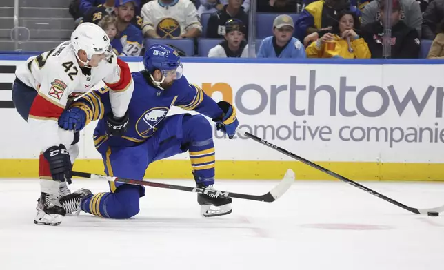 Buffalo Sabres right wing Alex Tuch (89) is pressured by Florida Panthers defenseman Gustav Forsling (42) during the first period of an NHL hockey game, Saturday, Oct. 12, 2024, in Buffalo, N.Y. (AP Photo/Jeffrey T. Barnes)