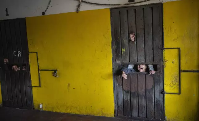 Prisoners talk to other prisoners through the gaps of a cell where they serve out punishment for trying to start a riot at the Juan de la Vega prison in Emboscada, Paraguay, Friday, July 12, 2024. (AP Photo/Rodrigo Abd)