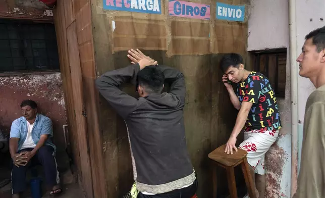 Inmates use a pay-by-the-minute phone booth set up and run by prisoners at the Regional Penitentiary in Villarica, Paraguay, Saturday, Aug. 31, 2024. Most inmates' calls get paid for by their families when they come to visit in person. (AP Photo/Rodrigo Abd)