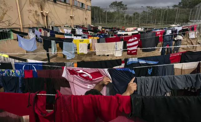 A prisoner hangs clothes to dry outside at the Juan de la Vega prison in Emboscada, Paraguay, Friday, July 12, 2024. (AP Photo/Rodrigo Abd)