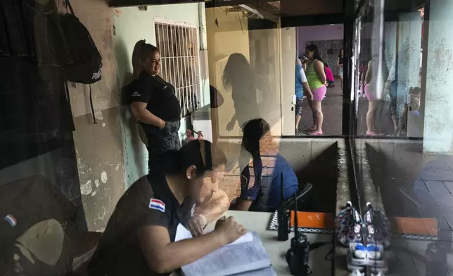 Security guards work at a checkpoint inside the Buen Pastor women's prison in Asuncion, Paraguay, Monday, Sept. 2, 2024. (AP Photo/Rodrigo Abd)