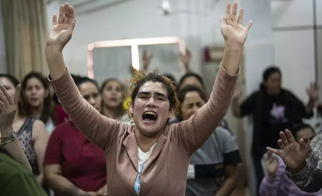 Inmates pray during an evangelical service at the Buen Pastor women's prison in Asuncion, Paraguay, Monday, Sept. 2, 2024. (AP Photo/Rodrigo Abd)