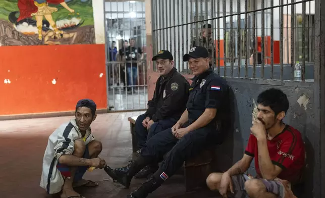 Prisoner Antolin Rojas, 32, shines the shoes of a prison guard, for 2000 Guaranies, or about 30 cents, at the Regional Penitentiary in Coronel Oviedo, Paraguay, Saturday, Aug. 31, 2024. (AP Photo/Rodrigo Abd)