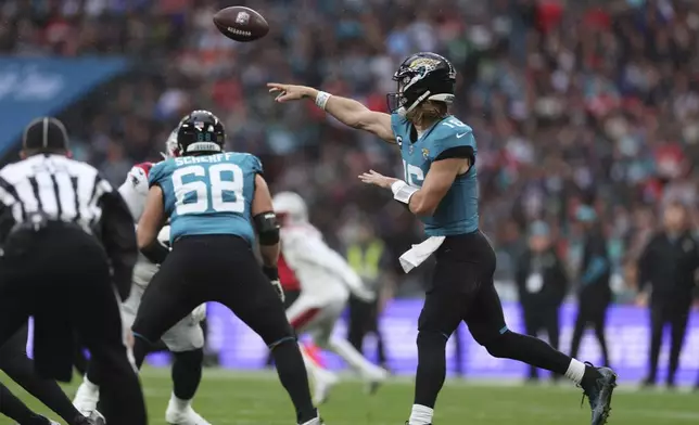 Jacksonville Jaguars quarterback Trevor Lawrence throws during the first half of an NFL football game against the New England Patriots, Sunday, Oct. 20, 2024, in London. (AP Photo/Ian Walton)