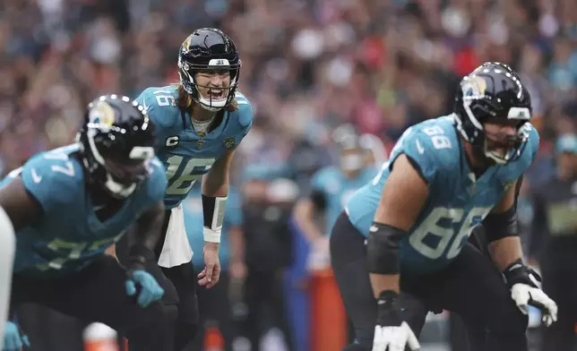 Jacksonville Jaguars quarterback Trevor Lawrence waits on the snap during the first half of an NFL football game against the New England Patriots, Sunday, Oct. 20, 2024, in London. (AP Photo/Ian Walton)