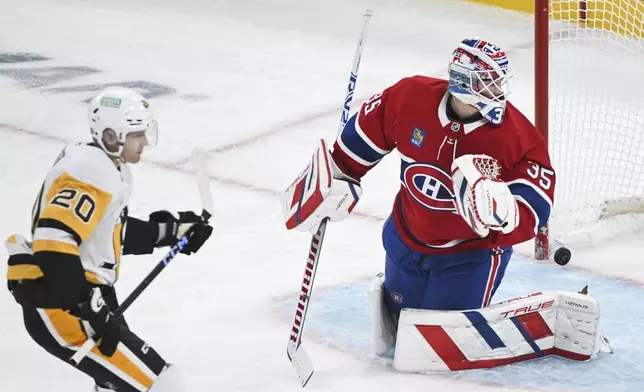 Montreal Canadiens goaltender Sam Montembeault looks back on his goal after being scored on by Pittsburgh Penguins' Lars Eller (20) during the first period of an NHL hockey game in Montreal, Monday, Oct. 14, 2024. (Graham Hughes/The Canadian Press via AP)