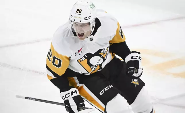 Pittsburgh Penguins' Lars Eller reacts after scoring against the Montreal Canadiens during the first period of an NHL hockey game in Montreal, Monday, Oct. 14, 2024. (Graham Hughes/The Canadian Press via AP)