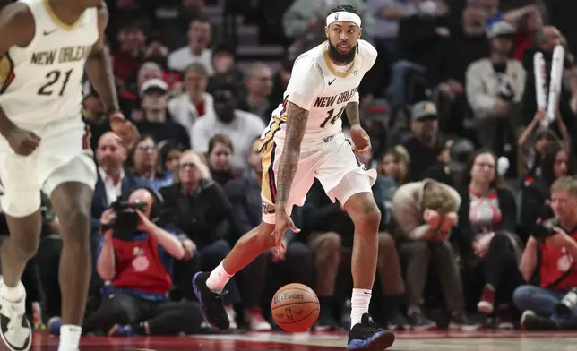 New Orleans Pelicans forward Brandon Ingram (14) brings the ball up court against the Portland Trail Blazers during the second half of an NBA basketball game Friday, Oct. 25, 2024, in Portland, Ore. The Pelicans won 105-103. (AP Photo/Amanda Loman)