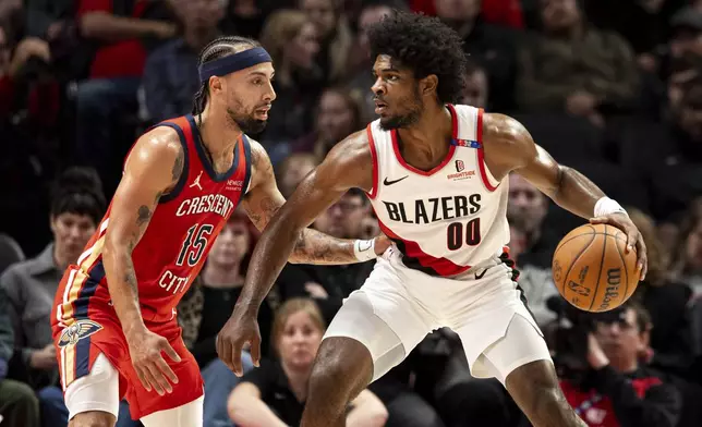 New Orleans Pelicans guard Jose Alvarado, left, defends against Portland Trail Blazers guard Scoot Henderson, right, during the first half of an NBA basketball game Sunday, Oct. 27, 2024, in Portland, Ore. (AP Photo/Howard Lao)